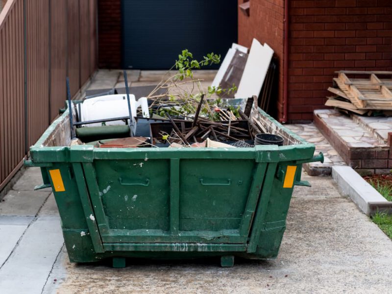 Green Skip Full of Waste Ready to Be Taken Away