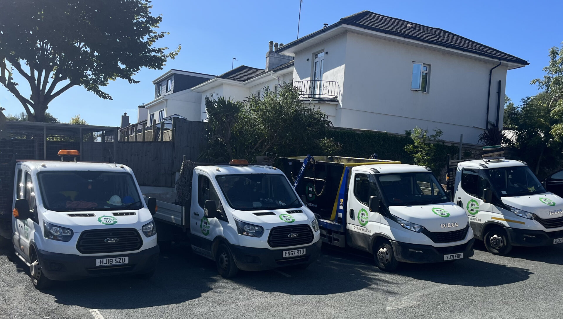 Four wedump4u vans parked