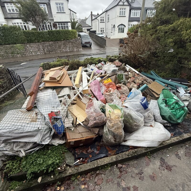 Bags of rubbish in clients front garden