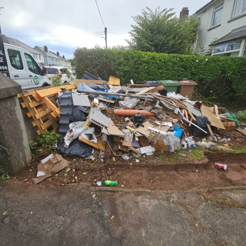 Pile of domestic rubbish in garden